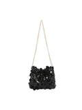 Black sequined handbag with a chain strap on a white background