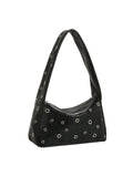 Black handbag with circular cutouts on a white background
