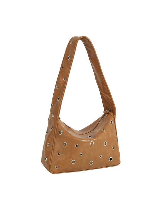 Brown leather handbag with decorative studs on a white background