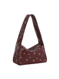Brown handbag with decorative studs on a white background